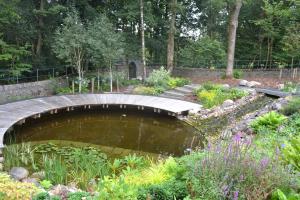 The informal edging contrasts with the formal circular decking The informal edging contrasts with the formal circular decking
