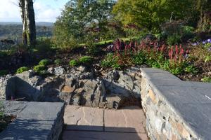 Stone wall, natural bedrock and planting Stone wall, natural bedrock and planting