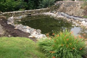 Stone wall dam with natural rock edges Stone wall dam with natural rock edges