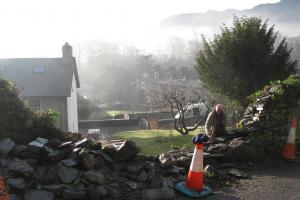 The drystone wall being built in Langdale Traditionally built drystone retaining wall in Langdale