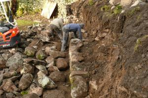 The middle terrace drystone retaining wall being built in Langdale Traditionally built drystone retaining wall in langdale