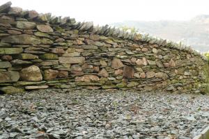 The new drystone built boundary wall in Langdale Traditionally built drystone retaining wall in Langdale