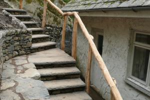 Stone steps with wooden handrail Lake district outdoor steps on hillside