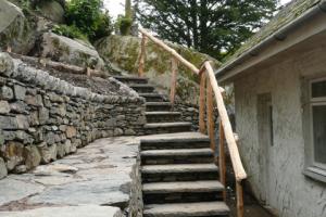 Stone steps with wooden handrail Lake district outdoor steps on hillside