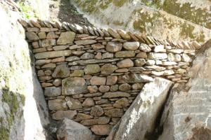 Further stone walling lower down in the Cumbrian hillside garden Curved stone wall in Cumbrian hillside garden